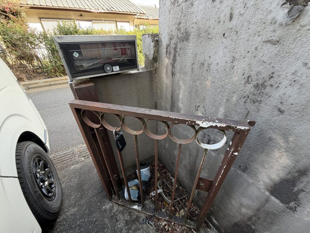 改修前の門まわり。さびた門扉と塀が残った入口(埼玉県比企郡鳩山町)